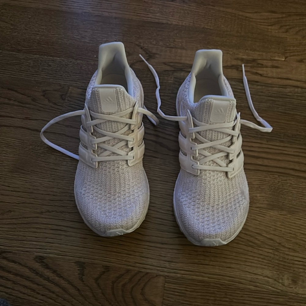 Women’s light pink ultra boost adidas sneakers.